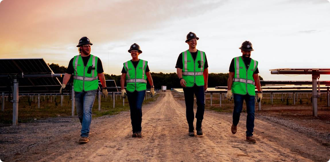 four employees walking on project site
