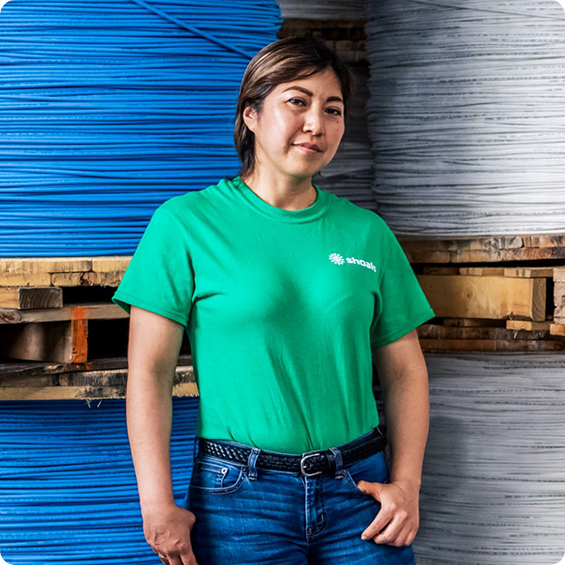 employee wearing a green shoals t-shirt on job site